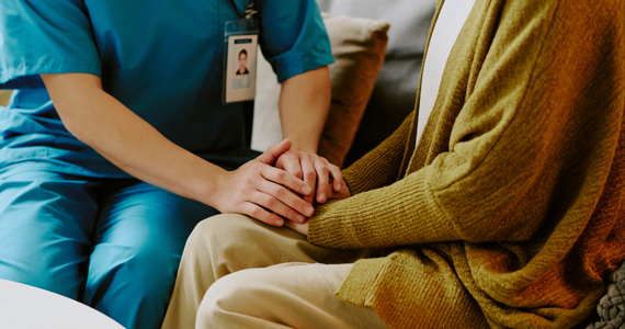 health worker holding a woman's hand